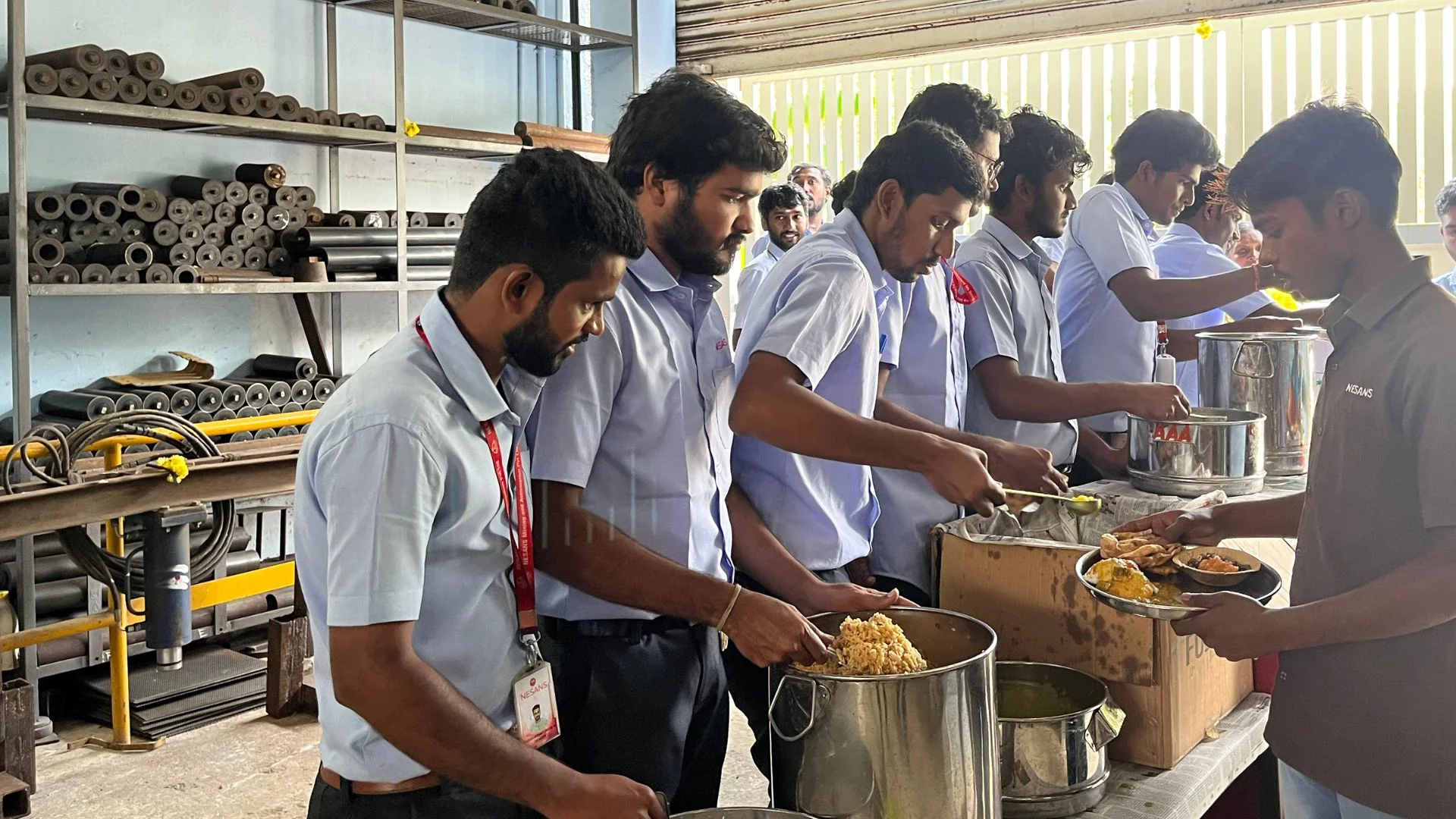 Employees serving food to each other during one of the yearly feasts in the company